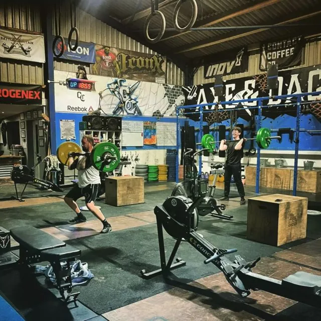 A busy session on the training floor, with members lifting, rowing and stepping onto boxes