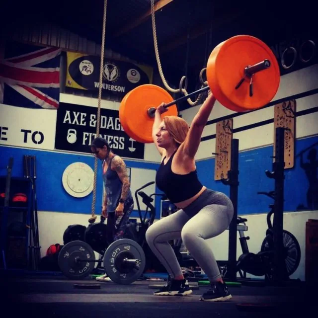A member catching a snatch overhead on the lifting platform